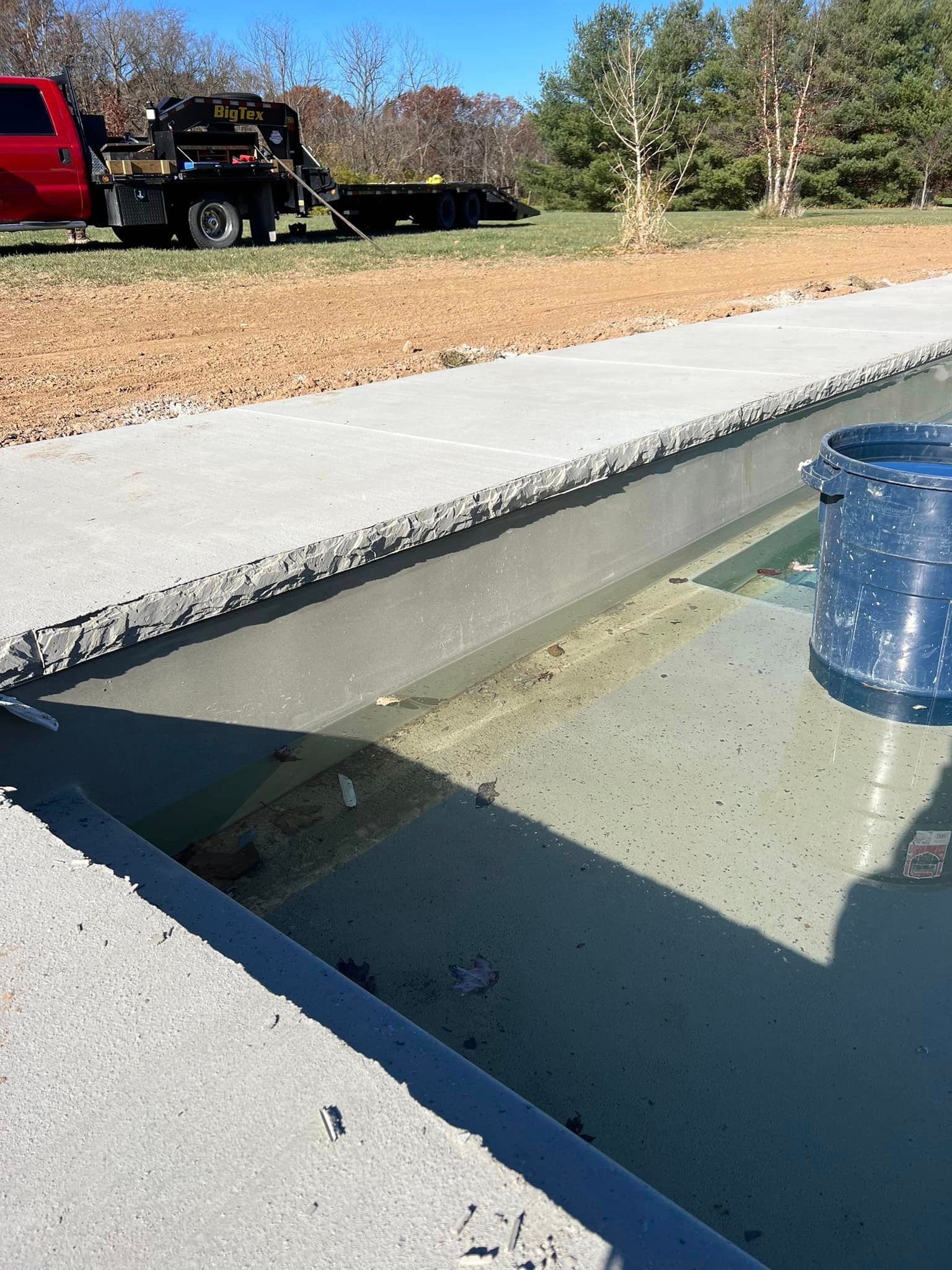 a tow truck is parked next to a swimming pool .