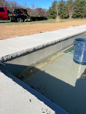 a tow truck is parked next to a swimming pool .