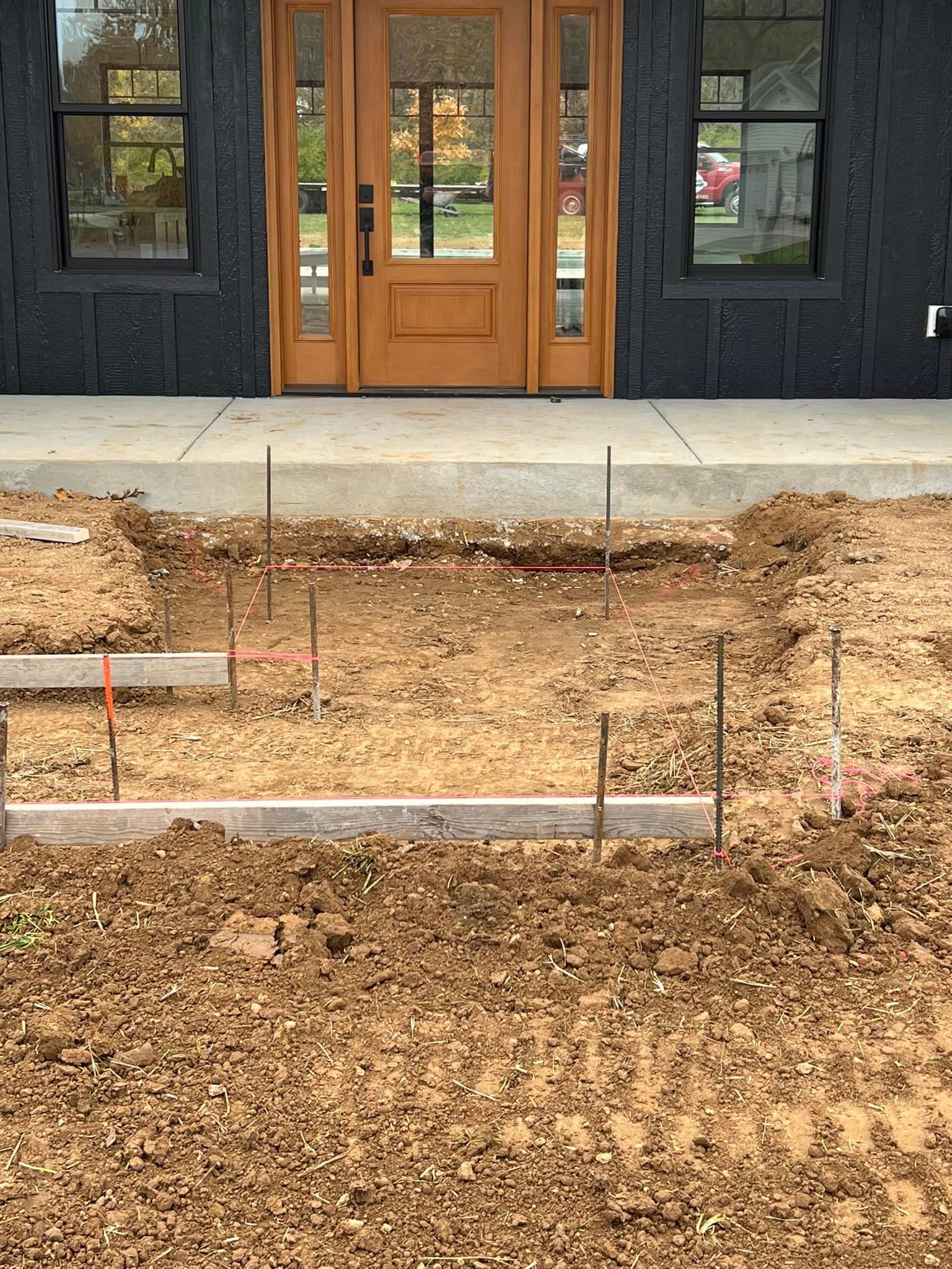 A building under construction with a lot of dirt in front of it.