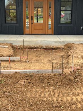 A building under construction with a lot of dirt in front of it.