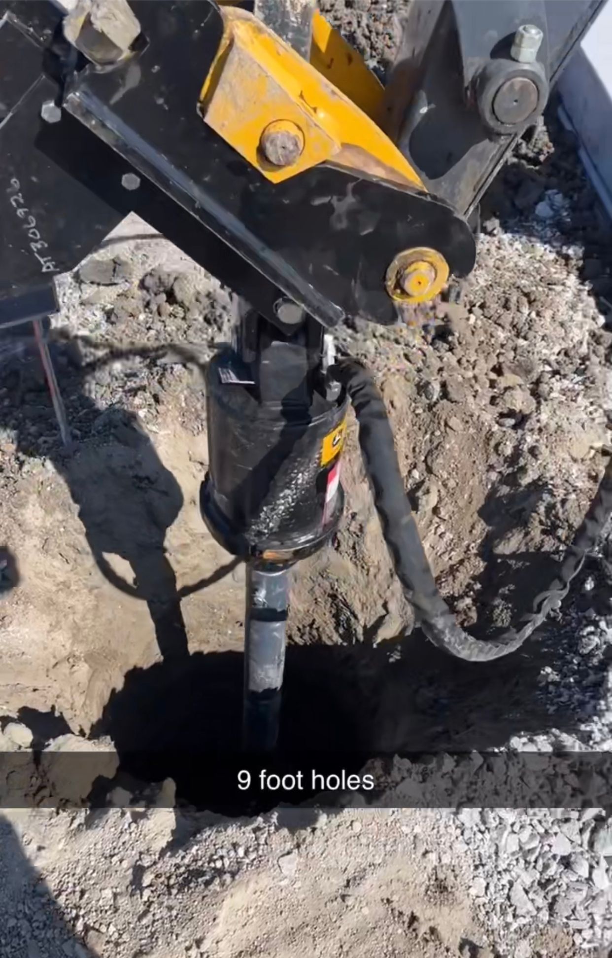 a machine is digging a hole in the ground .