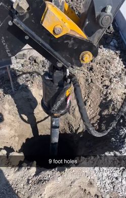 a machine is digging a hole in the ground .
