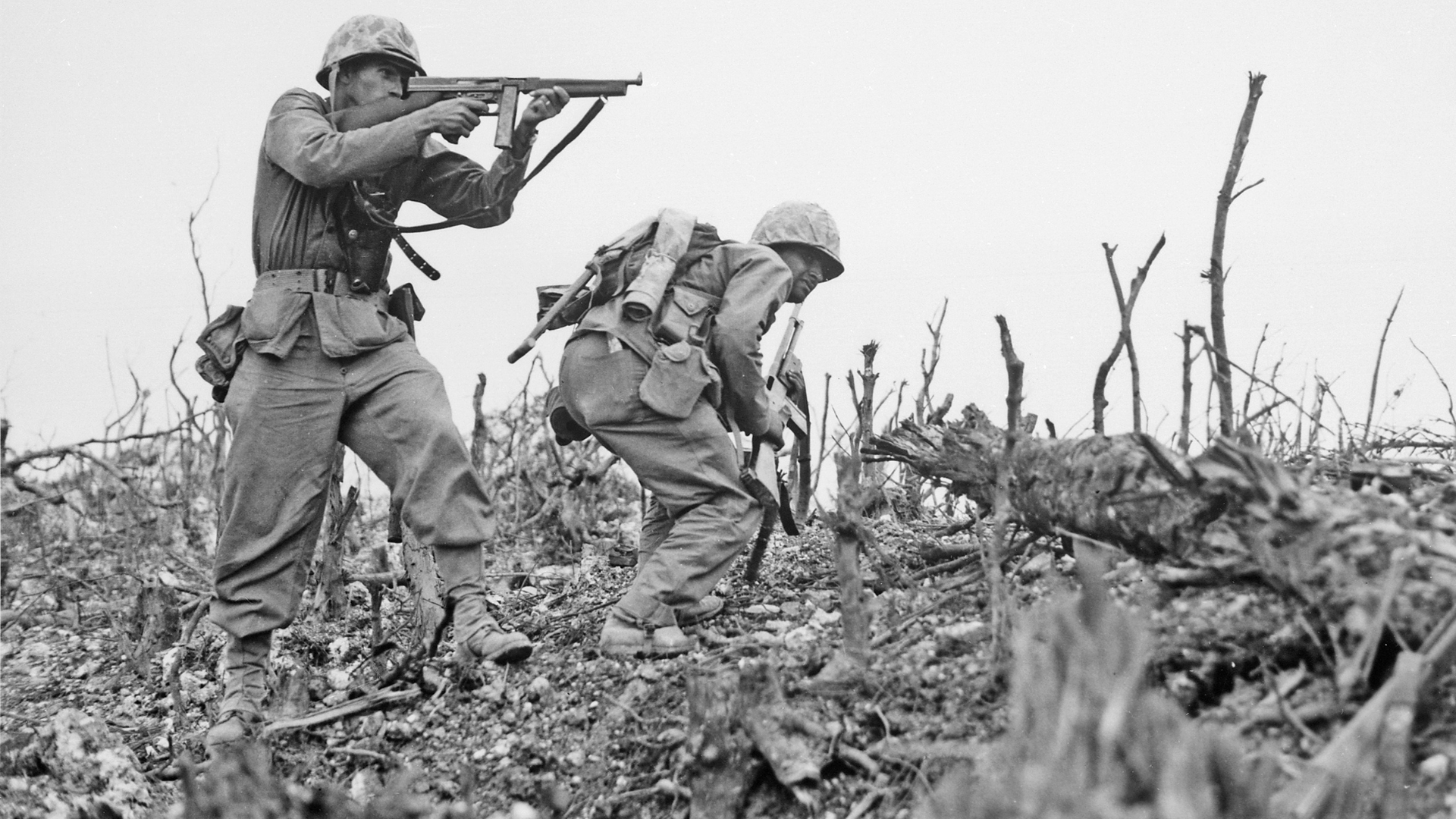 A black and white photo of two soldiers in a field.
