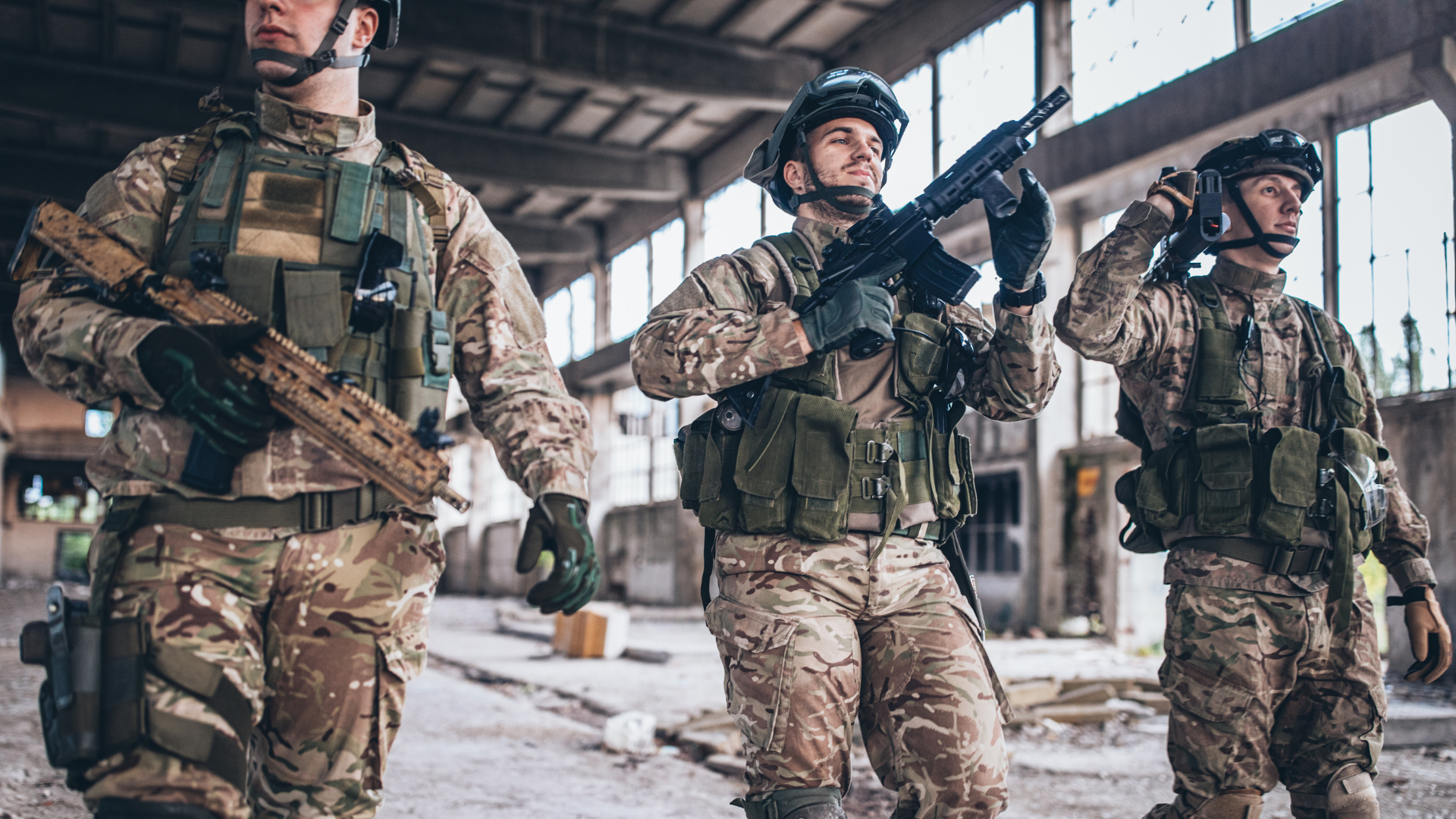 a photo of 3 military men holding guns walking out of a base