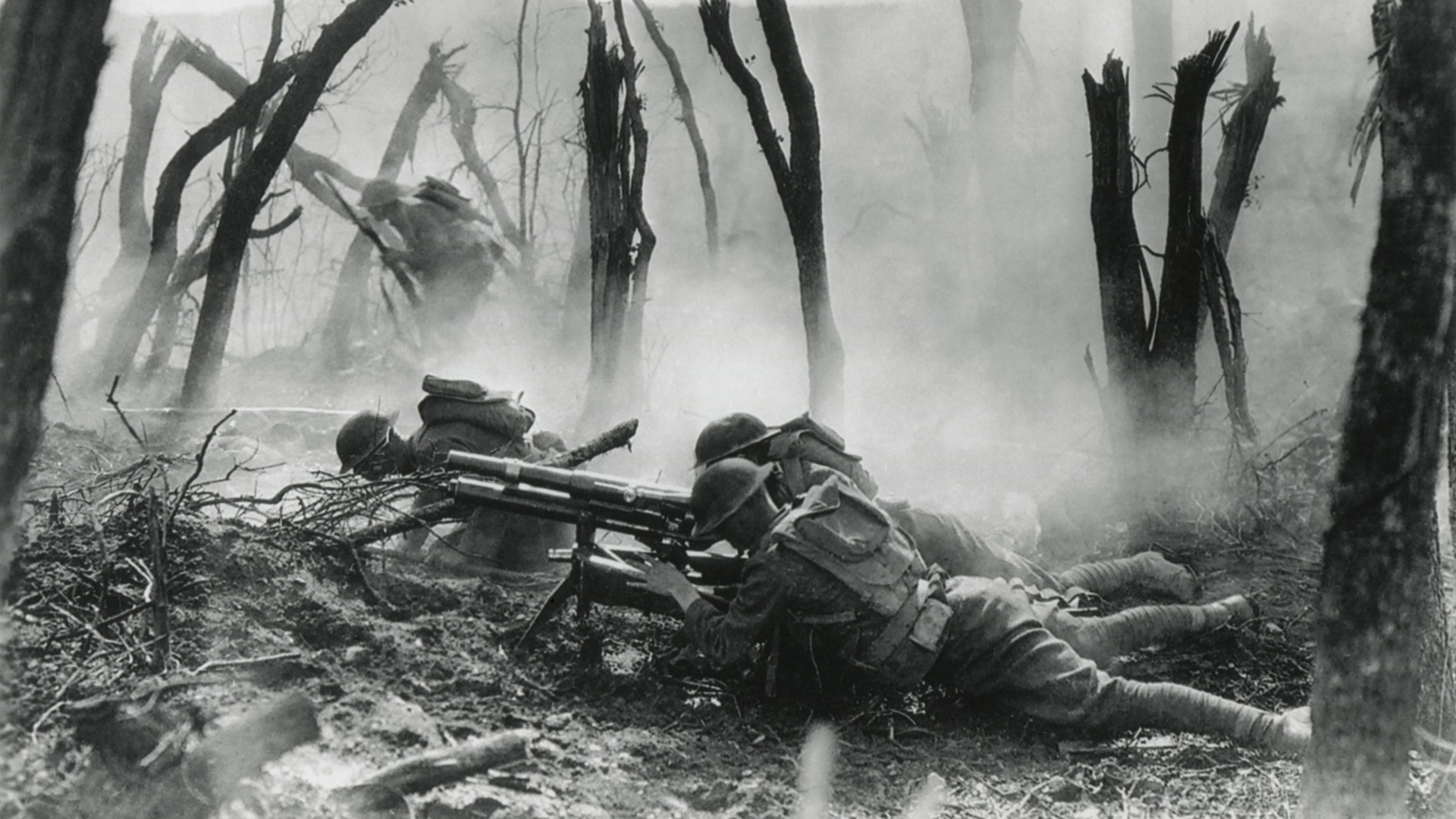 A black and white photo of soldiers in a forest.