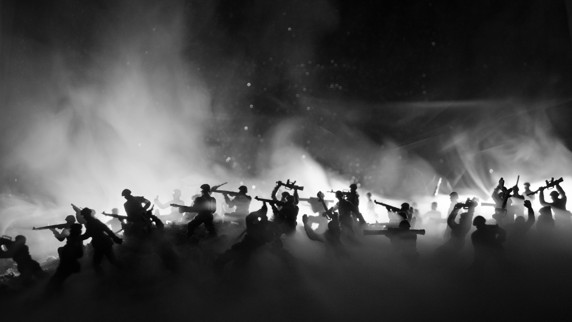 A black and white photo of a group of soldiers fighting in the fog.