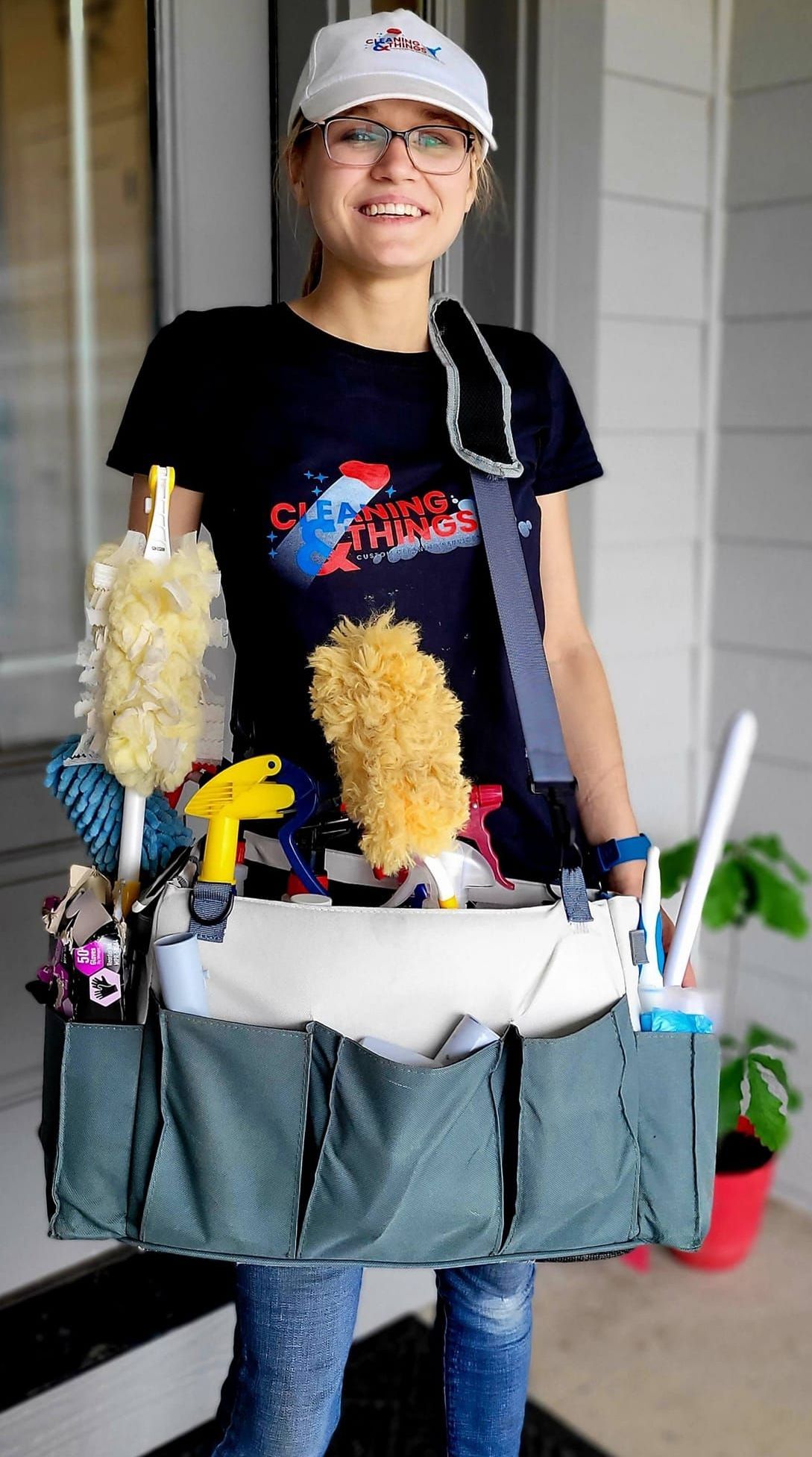 A woman is carrying a bag full of cleaning supplies.