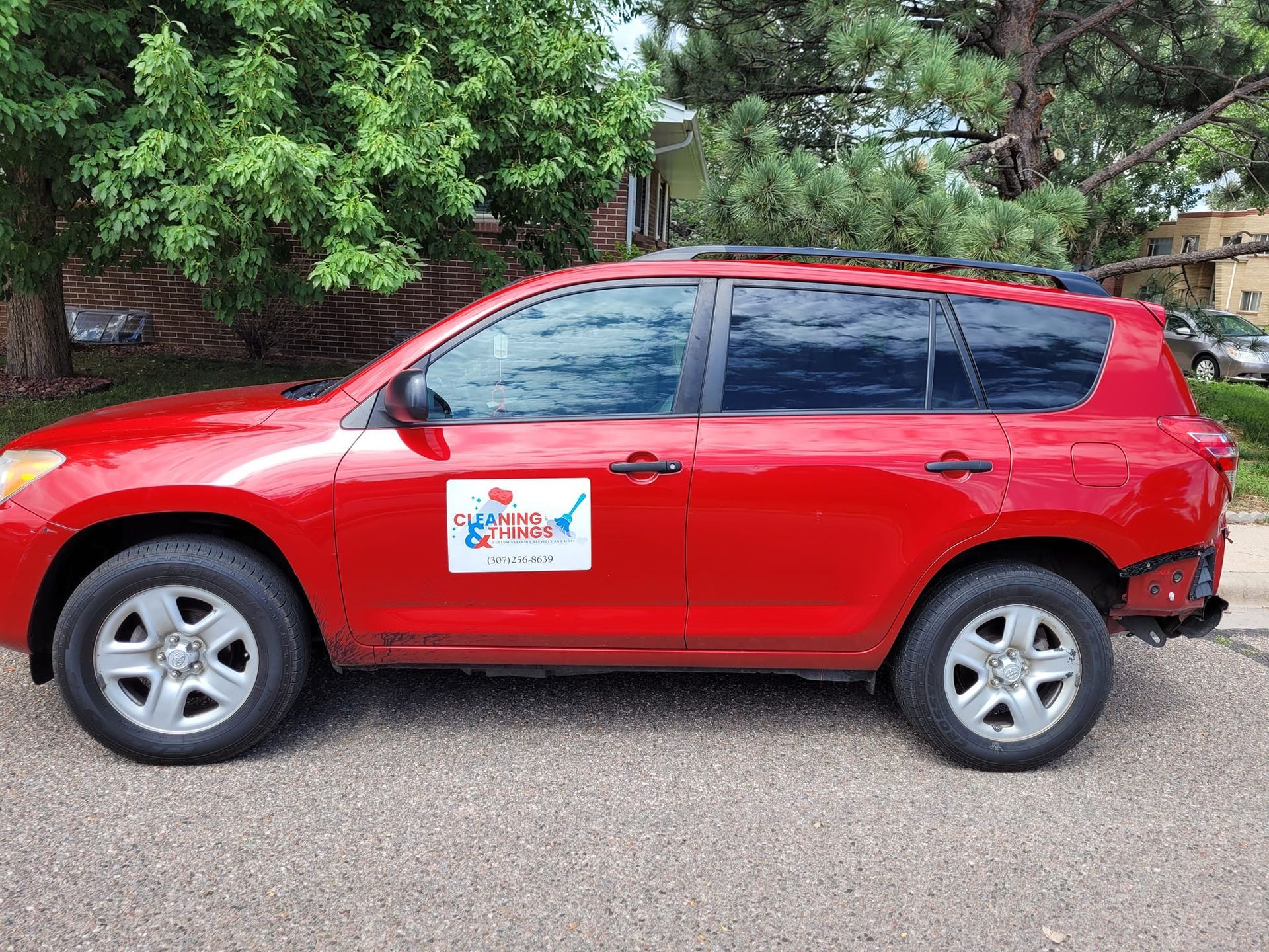 A red suv is parked on the side of the road.
