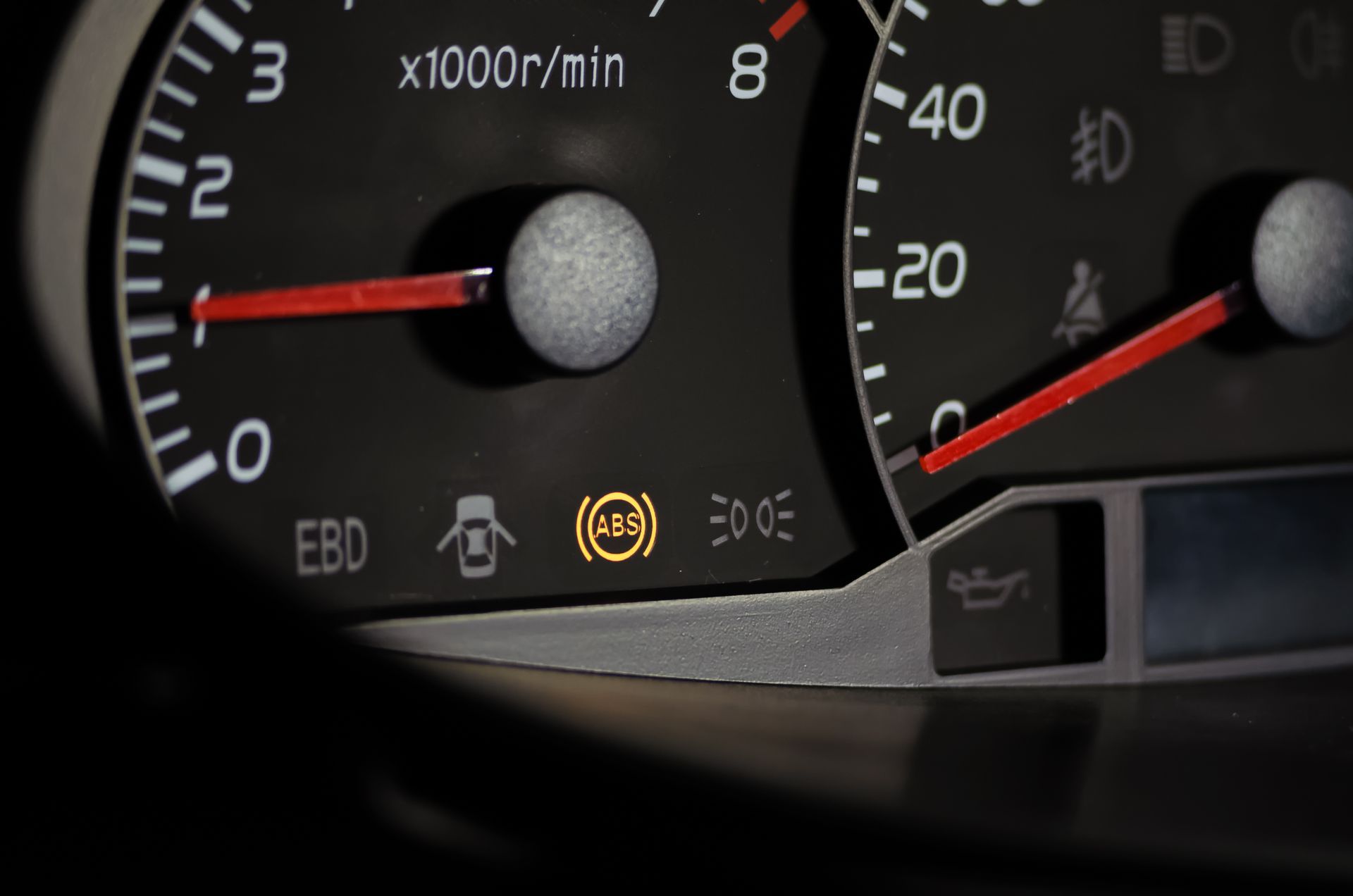 A close-up of a car dashboard with a warning light on | Auto Quality Sales & Service