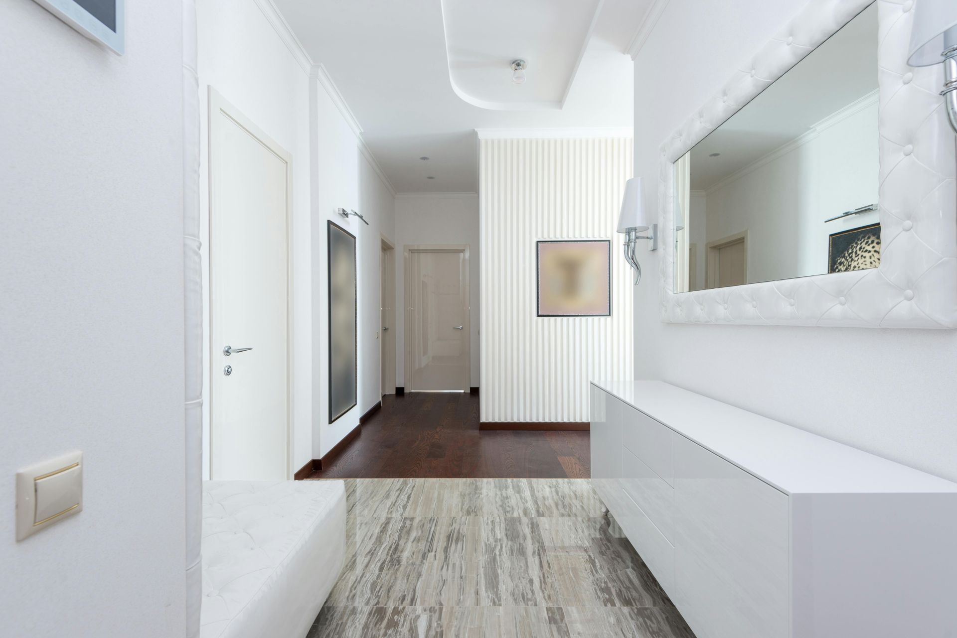 White hallway with wood floors, mirror, and light fixture in State College and Central PA 