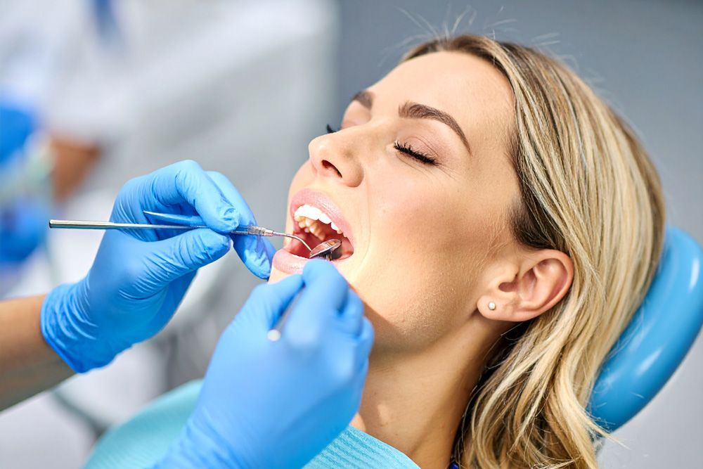 Woman in dental chair having teeth examined by a dentist  in Meridian, ID