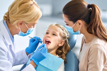 Child with a Parent having a dental checkup in Meridian, ID