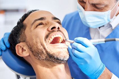 A man is having a dental cleaning in Meridian, ID