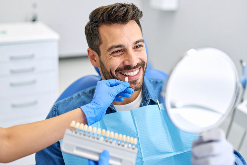 Patient checking different shades of veneer in Meridian, ID
