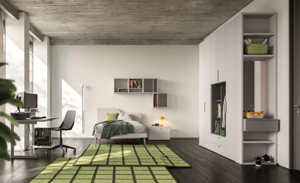 Camera da letto moderna con pavimento in legno scuro, pareti bianche, armadio grigio e tappeto verde.