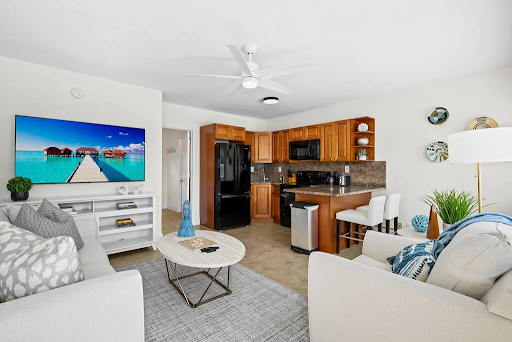 A living room with a couch , coffee table , and television.