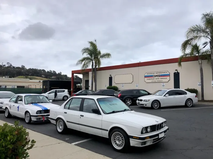 White BMWs Parked Outside Shop | Oceanside Motorsports Inc.