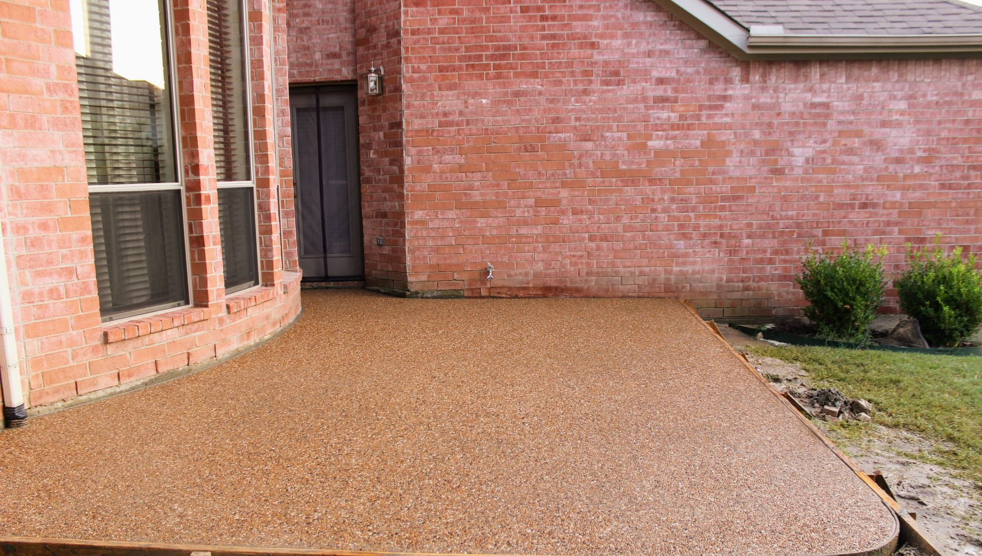 A group of construction workers are working on a concrete walkway.