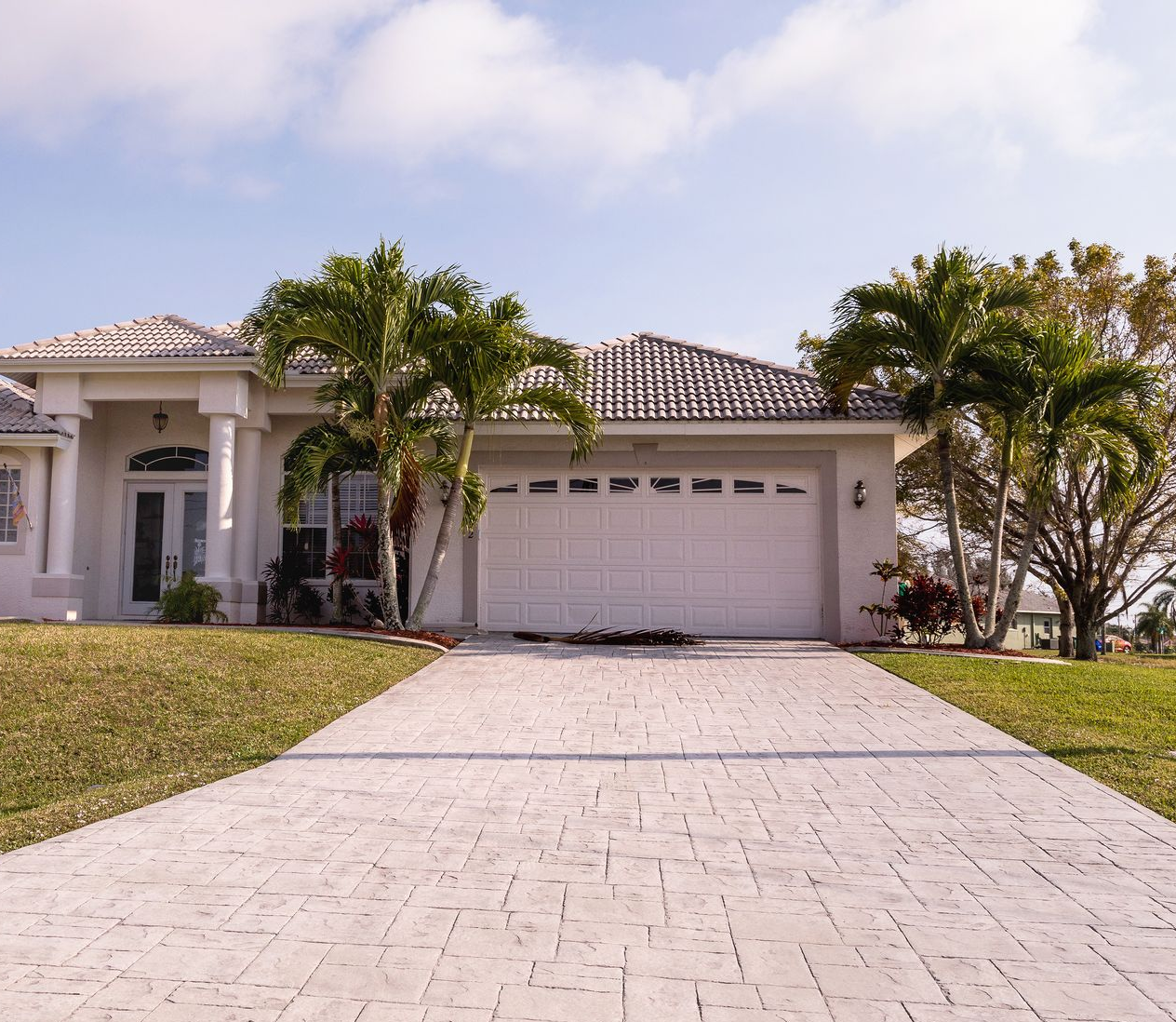 A group of construction workers are working on a concrete walkway.