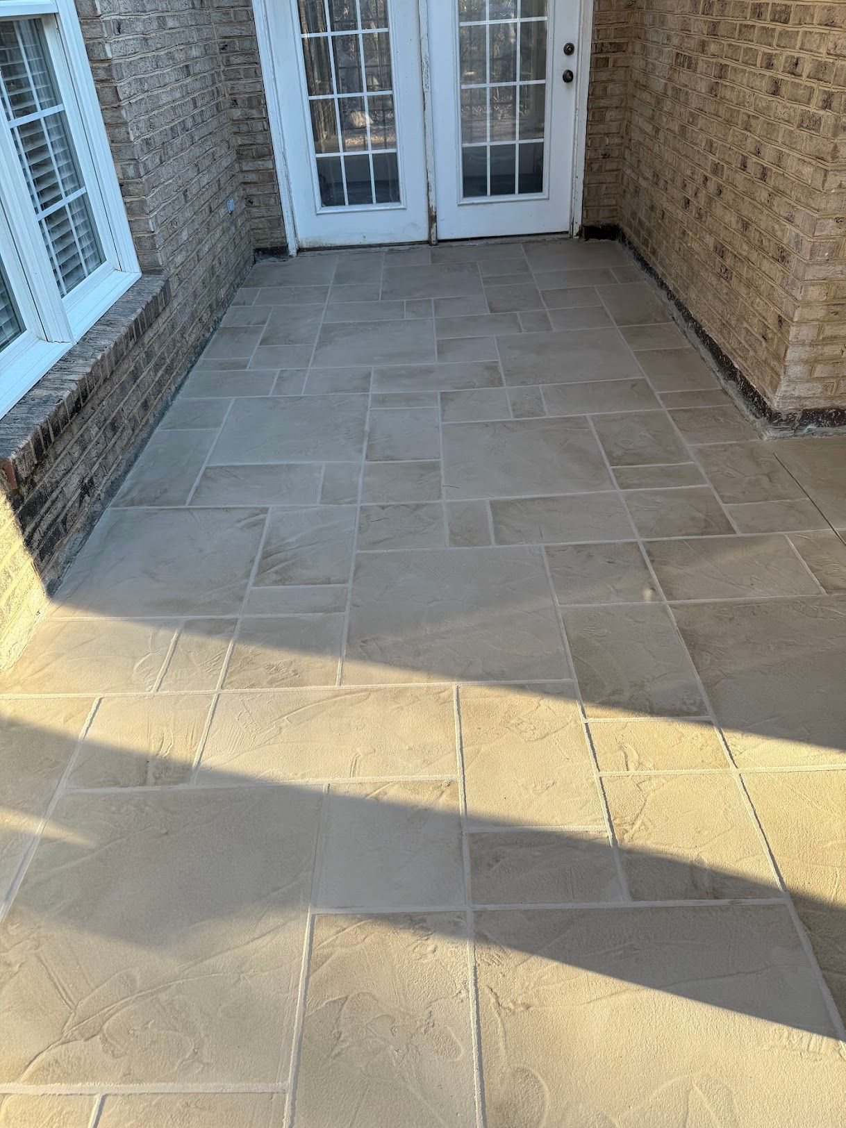 A group of construction workers are working on a concrete walkway.