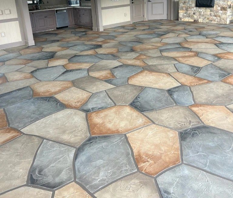 A large house with two garage doors and a concrete driveway.