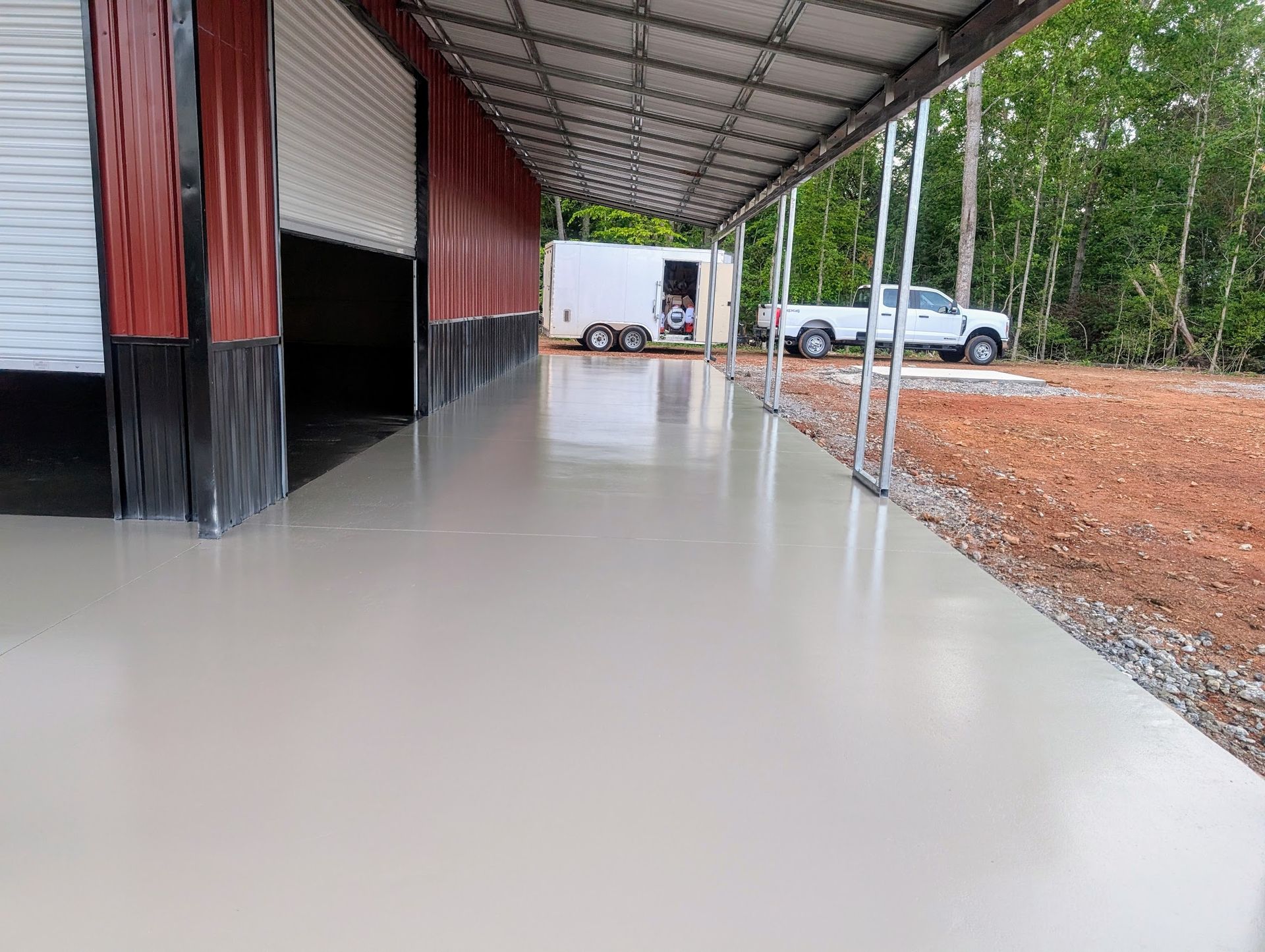 A group of construction workers are working on a concrete walkway.