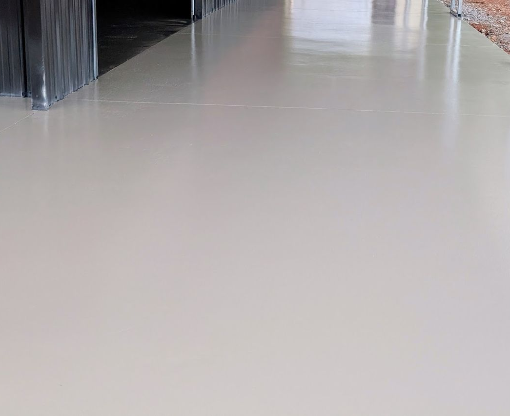 A large house with two garage doors and a concrete driveway.