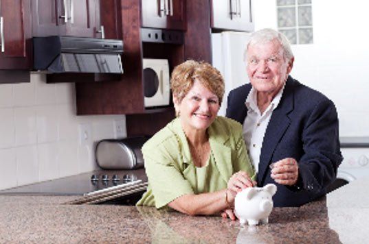 Old Couple Depositing on a Piggy Bank — Santa Cruz, CA — Dan Casagrande - Reverse Mortgages