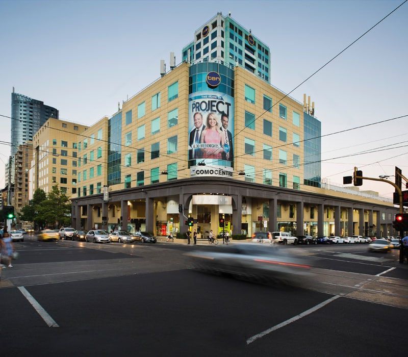 A large billboard on the side of a building says project