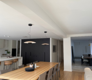 A dining room with a long wooden table and chairs