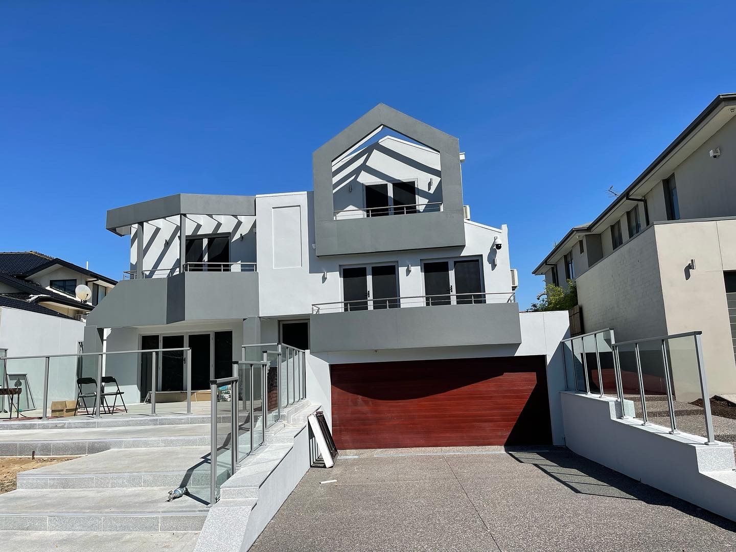 A large white house with a red garage door