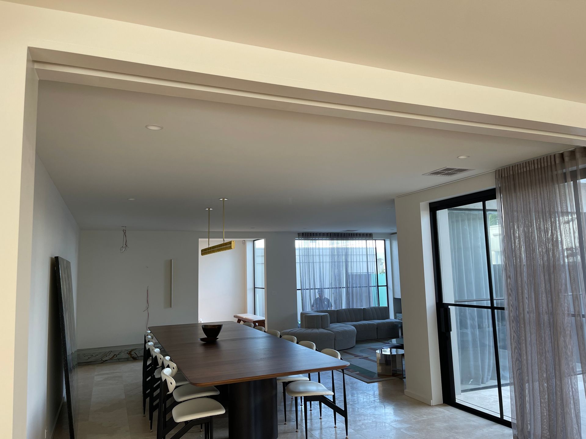 A large room with a dining table and chairs in it.