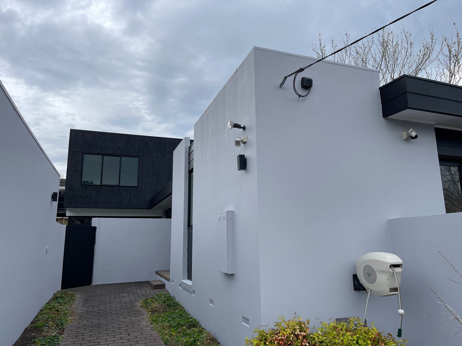 A white house with a black roof and a black door