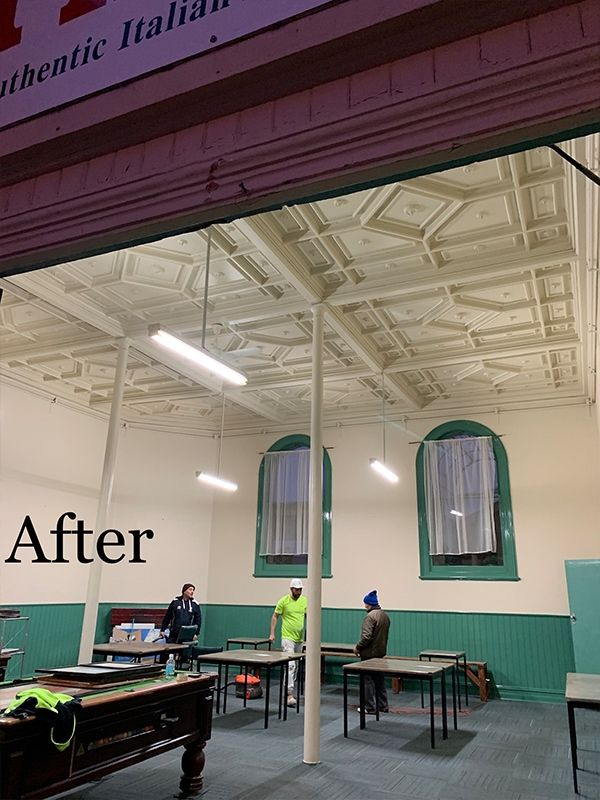A pool table in a room with a sign that says after