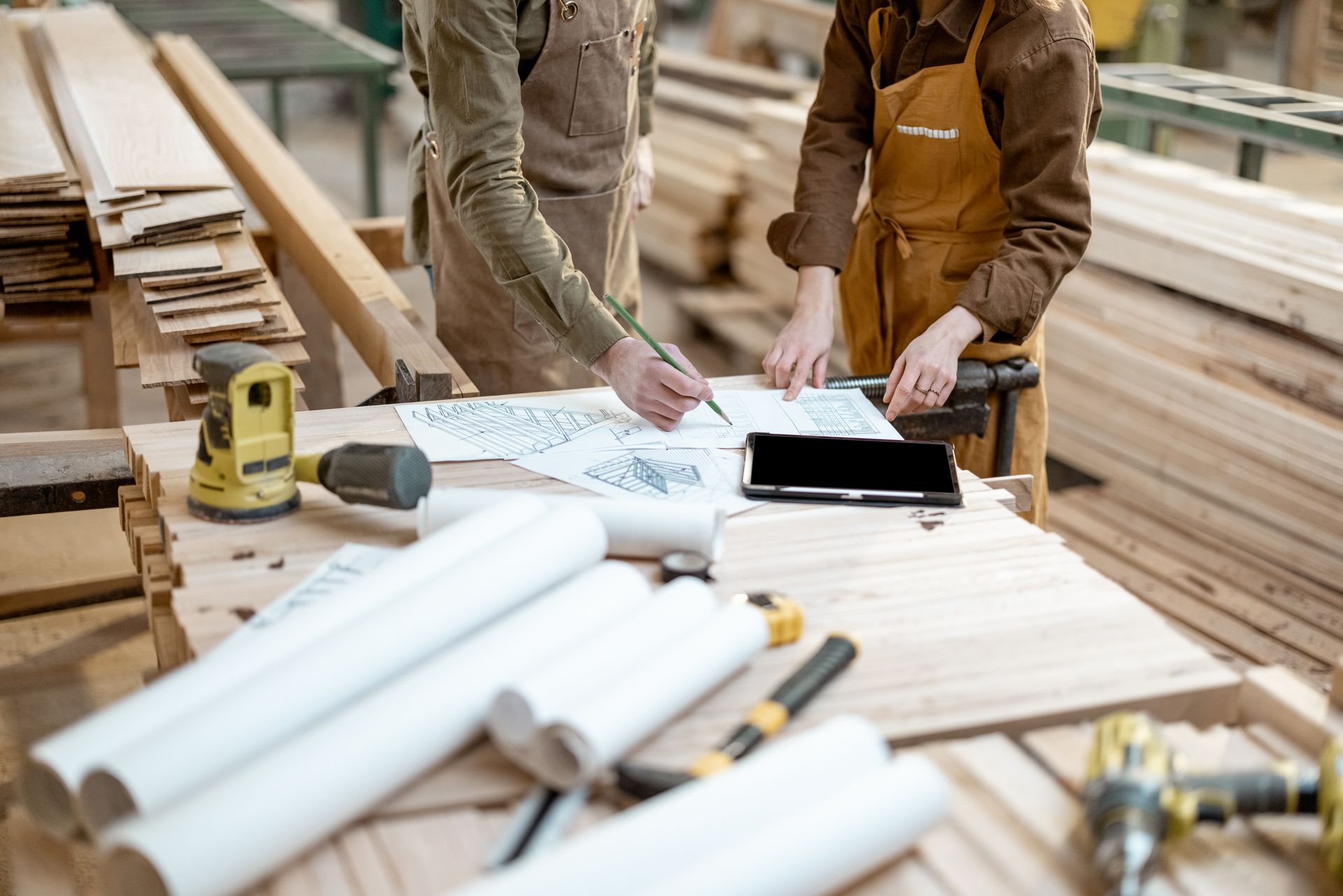 Carpenter crafting intricate woodwork design with precision and skill.