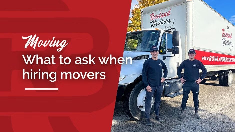 Two movers in front of a moving truck with 