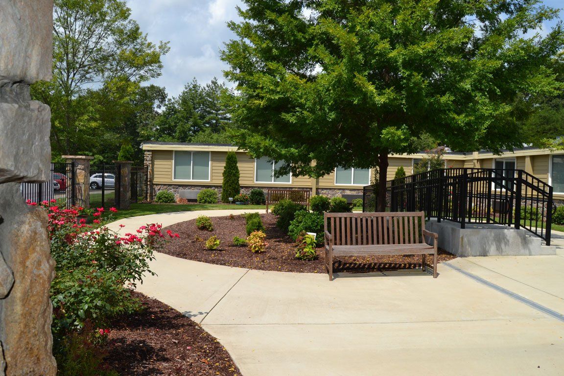 A wooden bench sits in front of a building