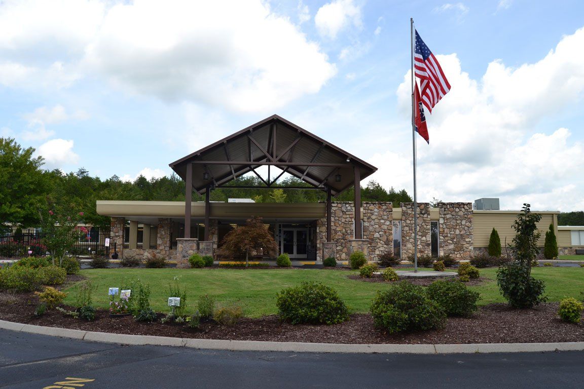 An american flag is flying in front of a building