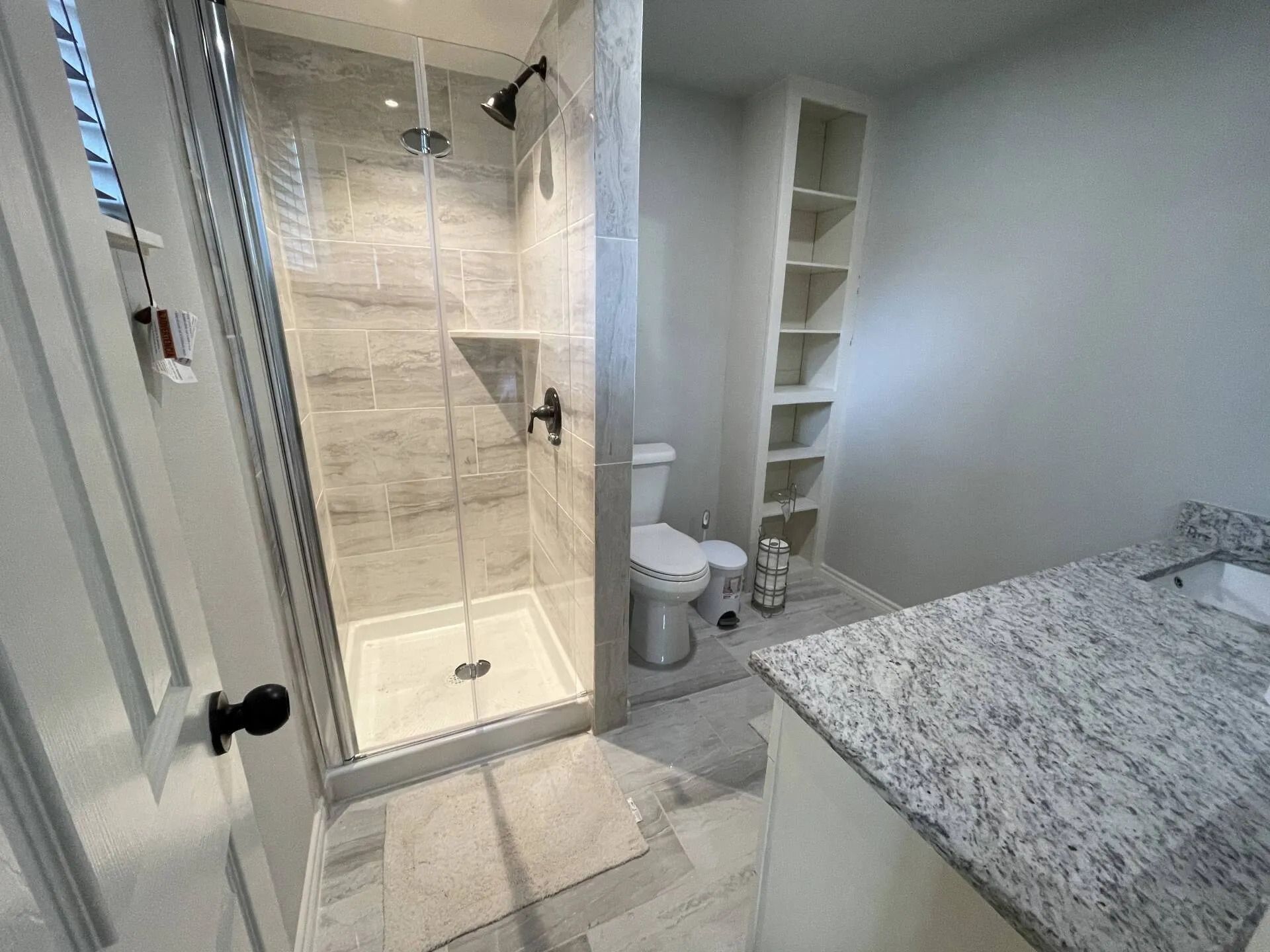 a bathroom with a walk in shower , toilet and sink .