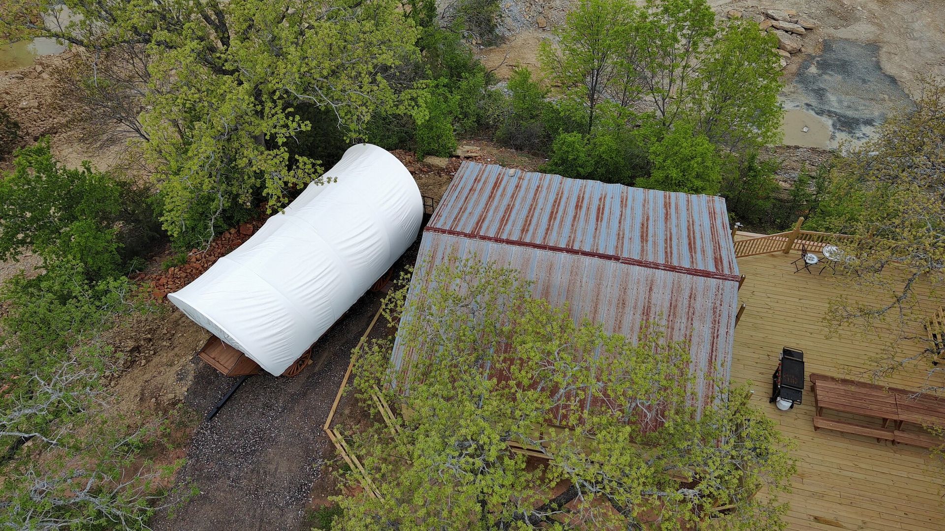an aerial view of a shed with a large white object on top of it .