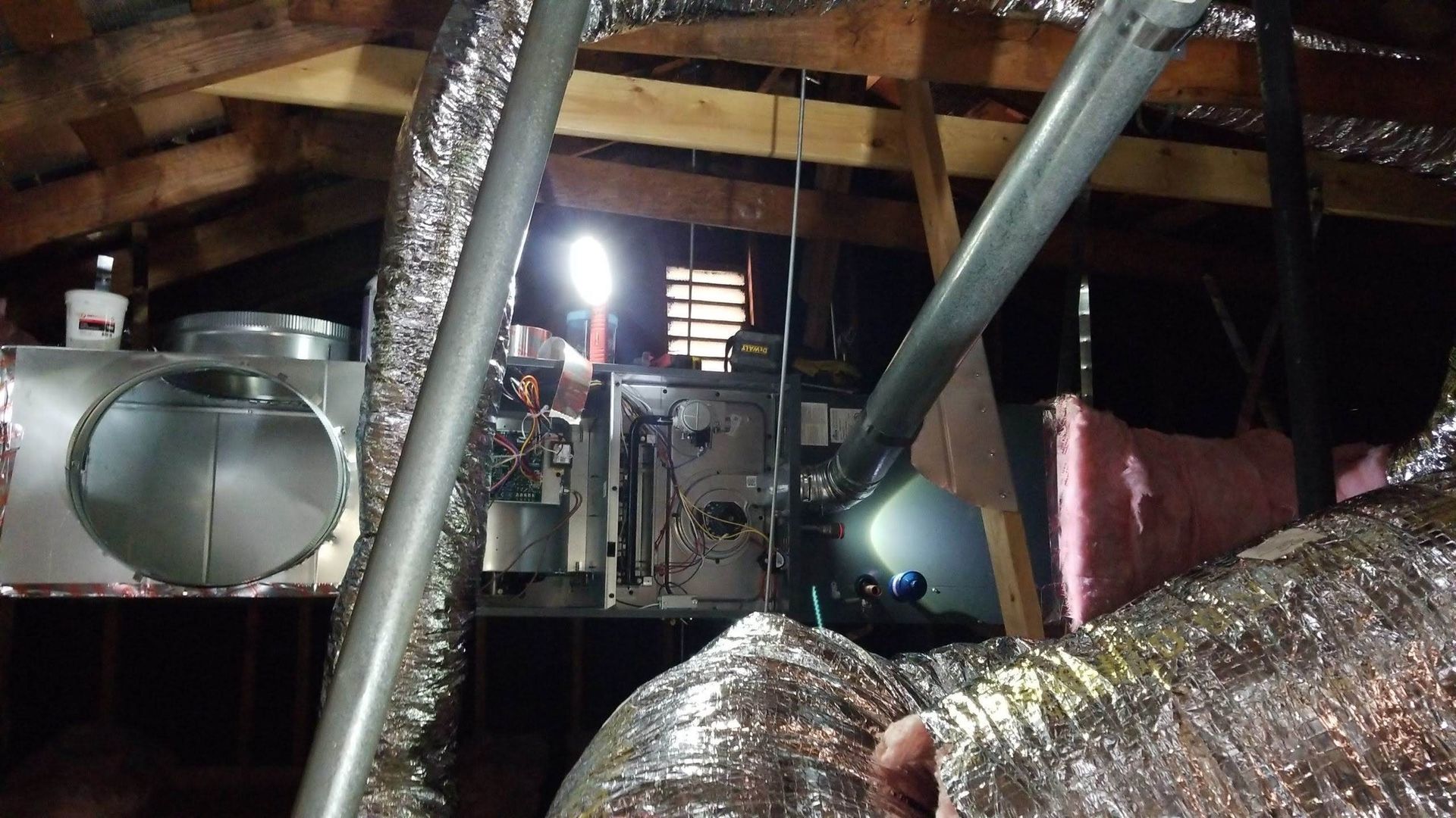 A room with a lot of pipes hanging from the ceiling