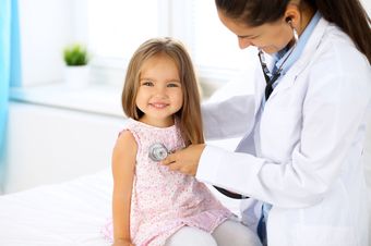 sick child being examined by doctor