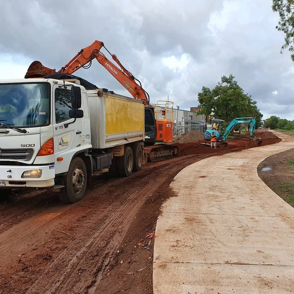 A Dump Truck is Driving Down — Diggamen Civil Contracting in Tivendale, NT