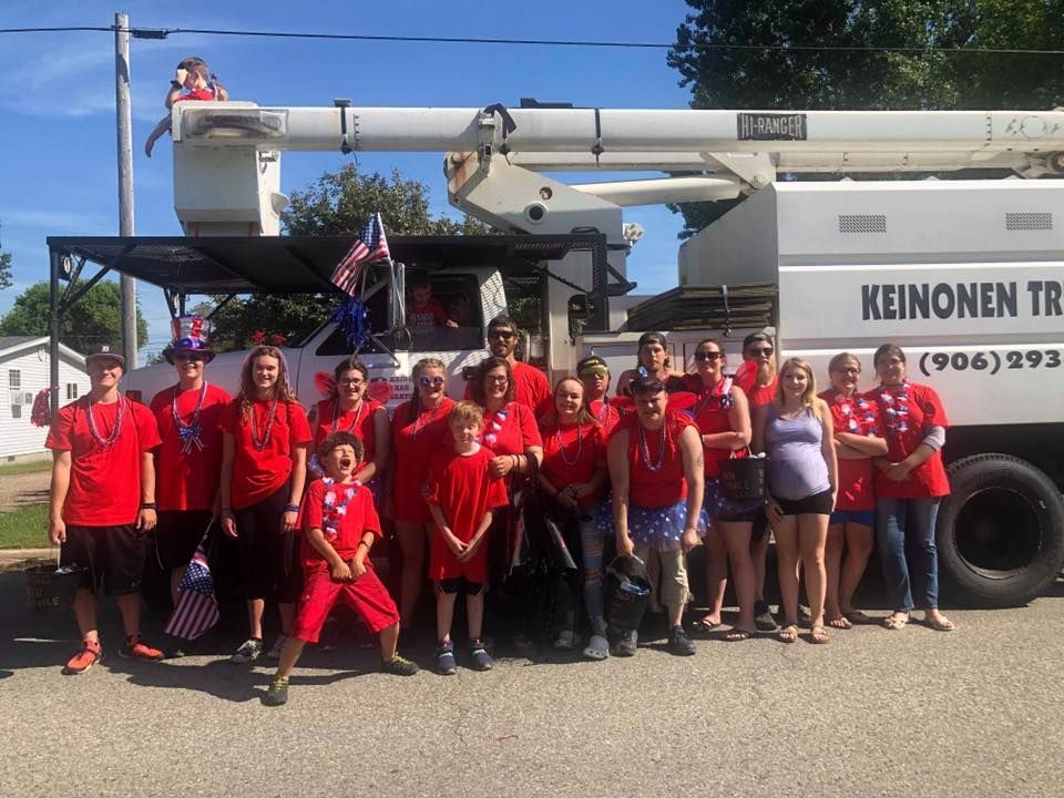 A group of people are posing for a picture in front of a truck.