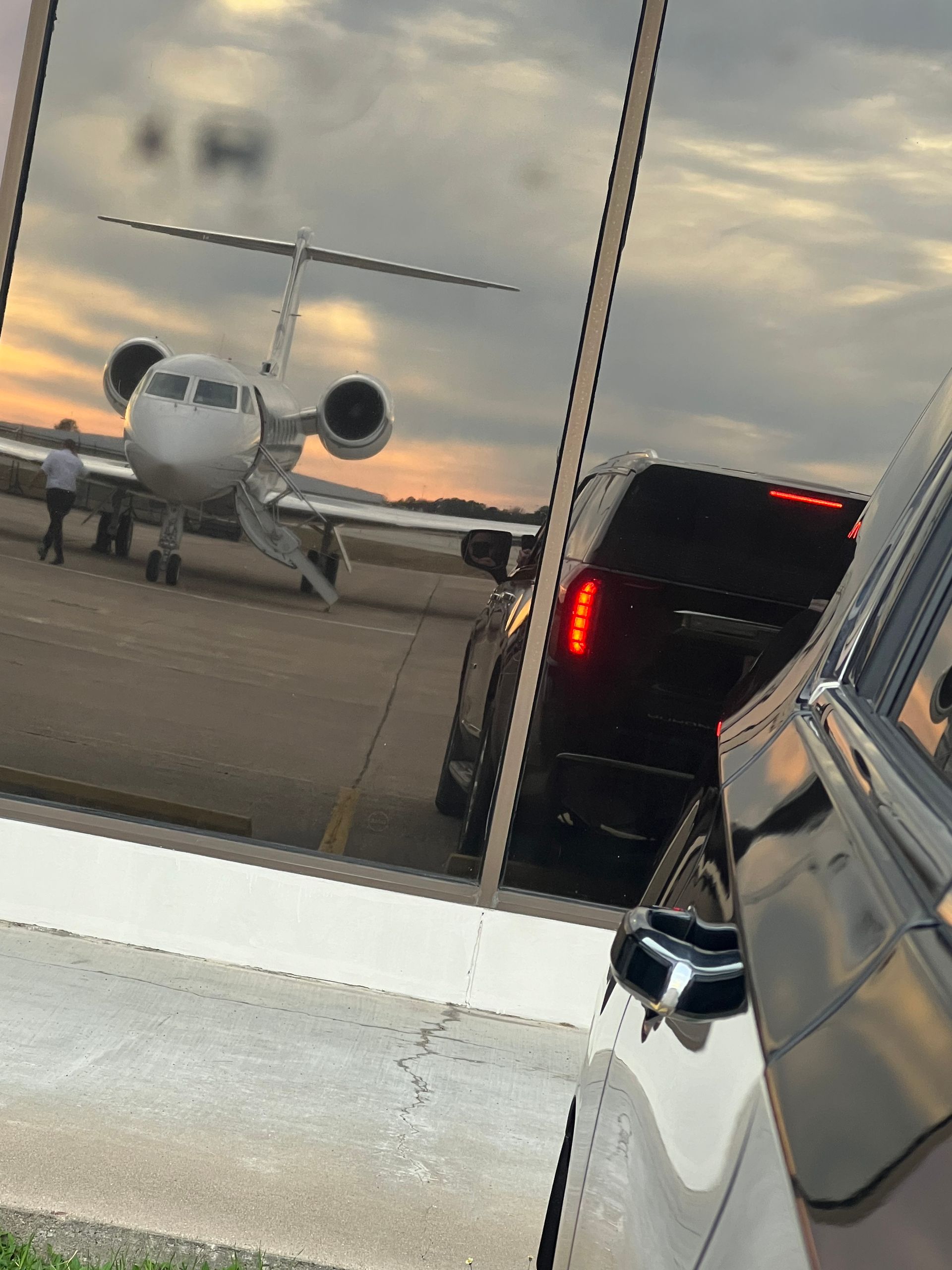 A reflection of an airplane in a car window