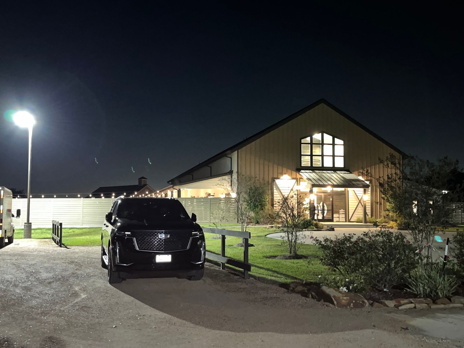 A car is parked in front of a building at night