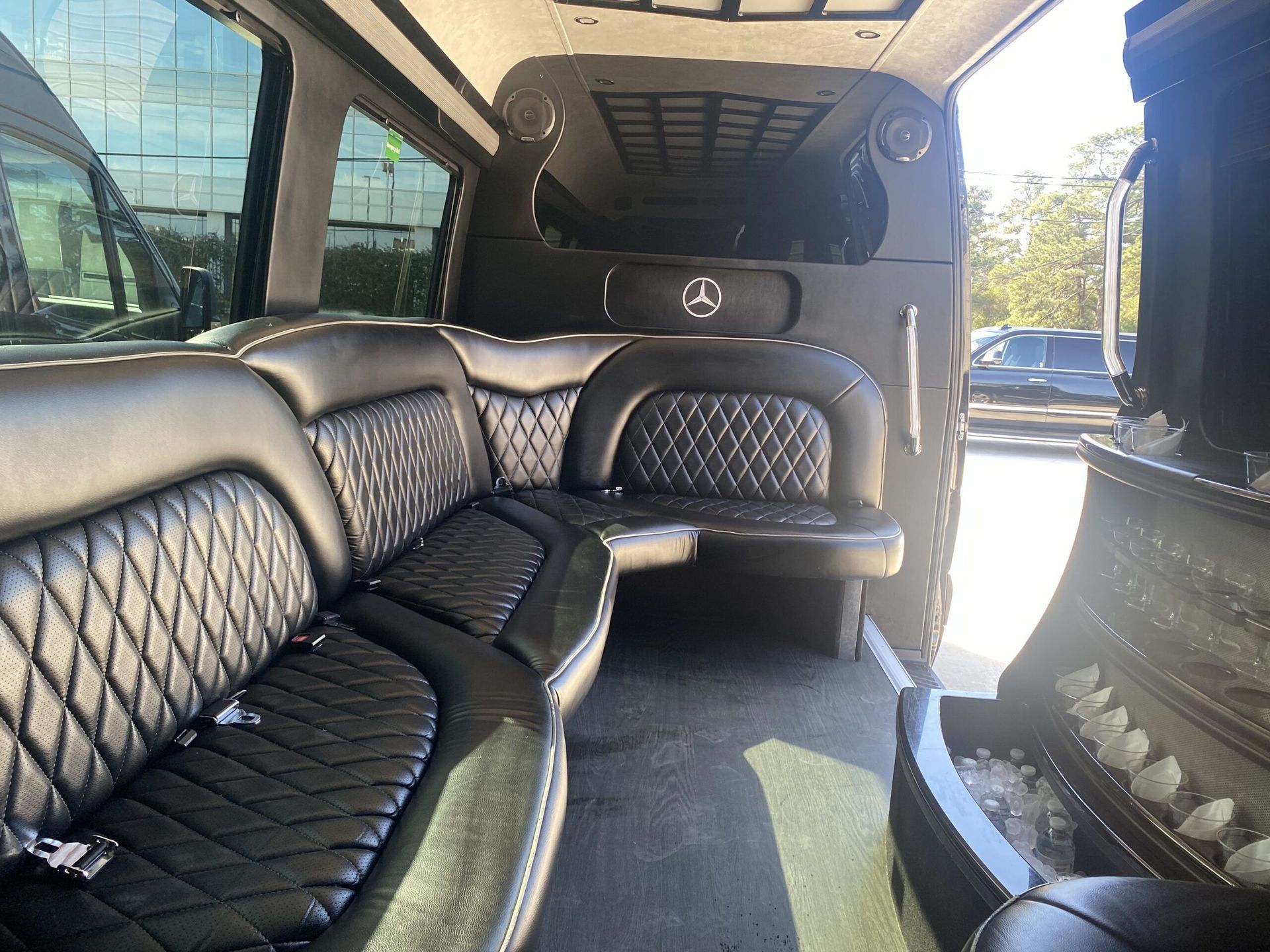 The inside of a mercedes van with black leather seats