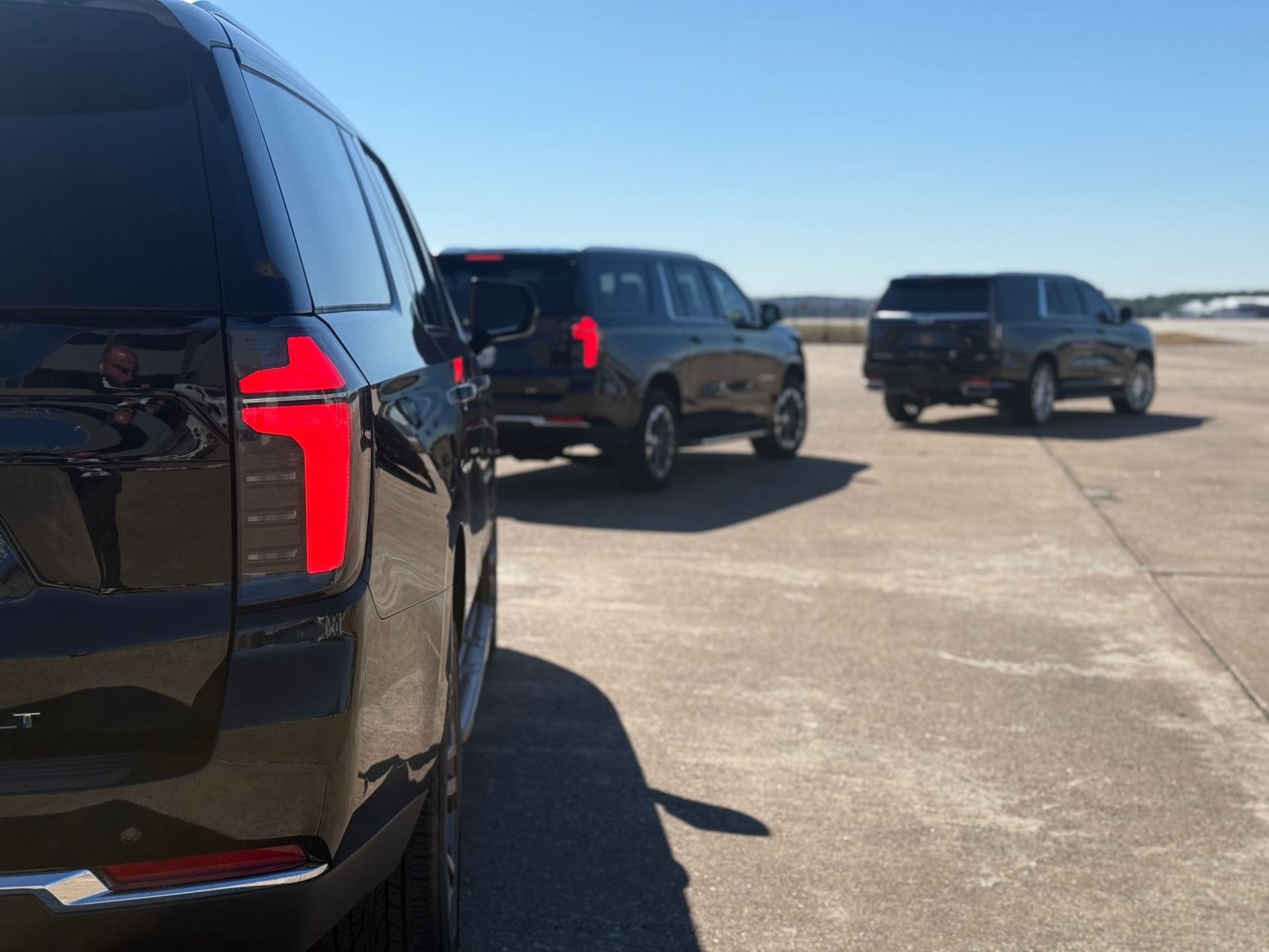 Airport transfers — black SUV fleet on tarmac