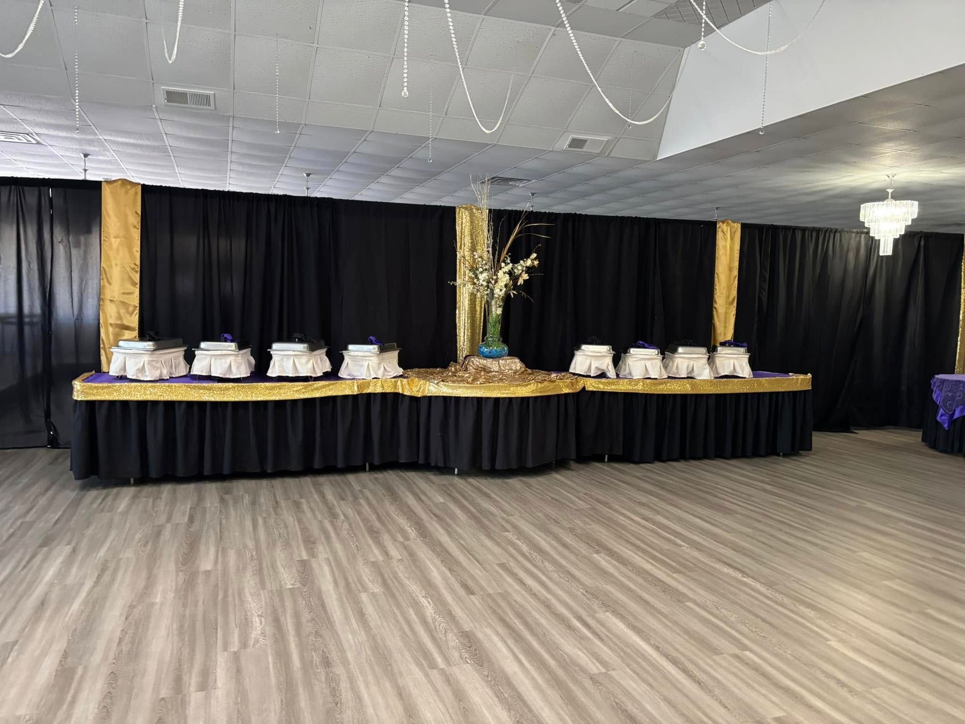 A large empty room with a buffet line in the middle of it.