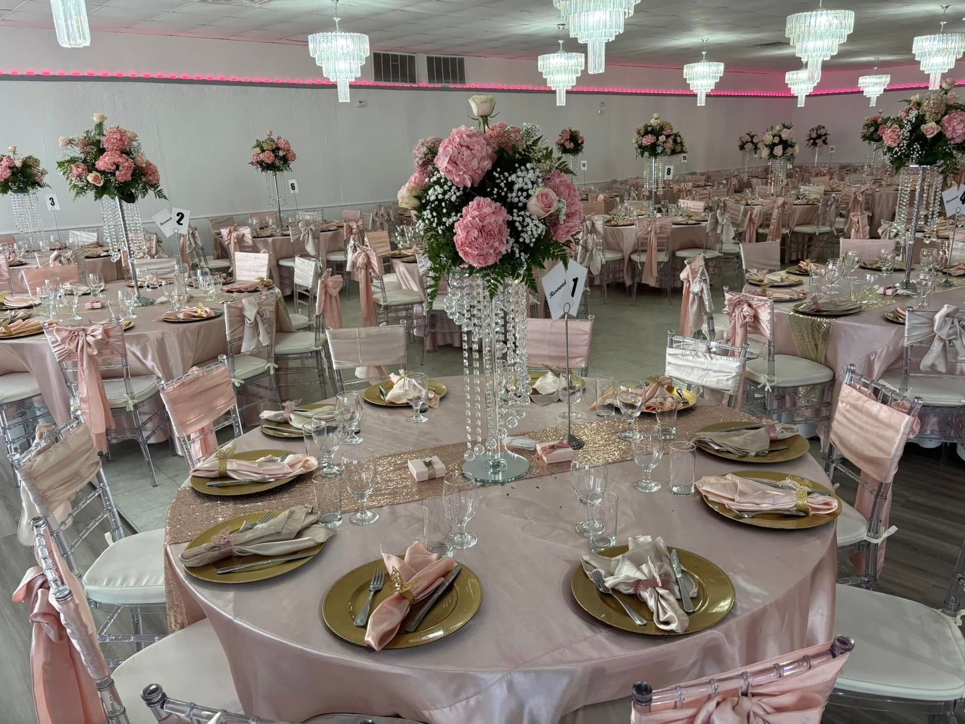 A large room with tables and chairs set up for a wedding reception.